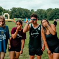 Representatives and first-year students holding their noses after water activities.
