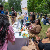 Representatives at a Black Student Success Center booth greeting First-year students.