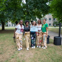 A group of representatives smiling and holding a sign that reads 'That's that me'.
