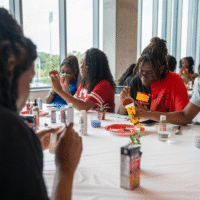 First-year students at a table painting plant pots.