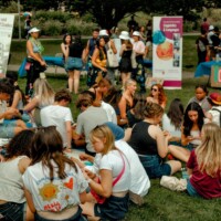 A group of First-year Students sitting in circles talking.