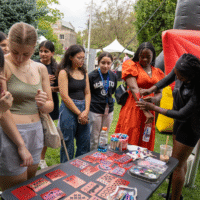 Representatives painting designs on first-year arms.