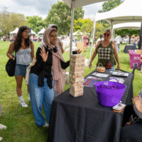 First year students playing Jenga at a booth.