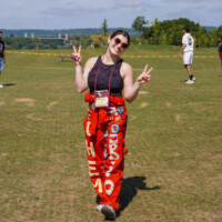 Faculty Representative making peace signs with their hands and smiling.