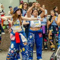 Faculty representatives guiding cars during Move-In weekend.