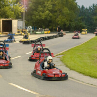 First-year students driving go-karts on a track.