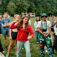 First-year student throwing a ball playing a carnival game.
