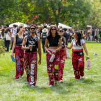 Representatives walking and smiling, holding water bottles.