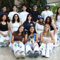 Faculty representatives posing for a photo in front of a waterfall in Michael DeGroote Centre for Learning and Discovery (MDCL).