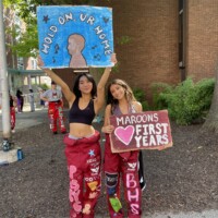 Representatives holding up signs that read 'HOLD ON, UR HOME' and 'MAROONS LOVE FIRST YEARS'.
