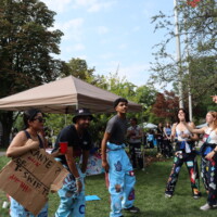 Faculty representatives facing each other performing their welcome week cheers.