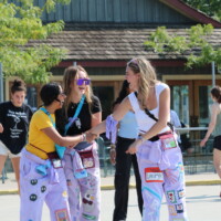 Faculty representatives smiling and laughing while rollerblading.