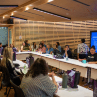 Indigenous student success centre (ISSC) representatives sitting at a long table.